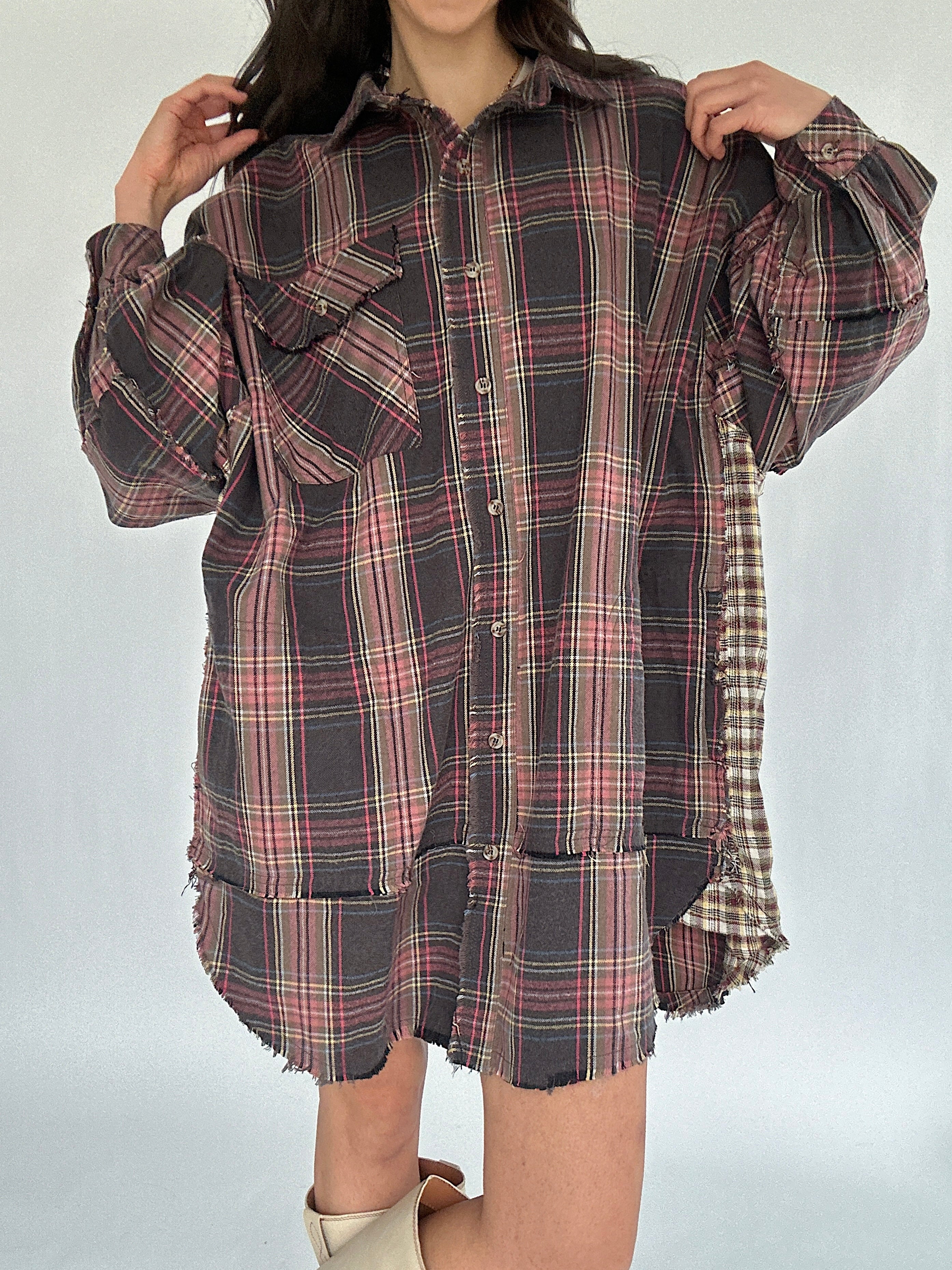 Plaid shirt dress worn by a person on a white background