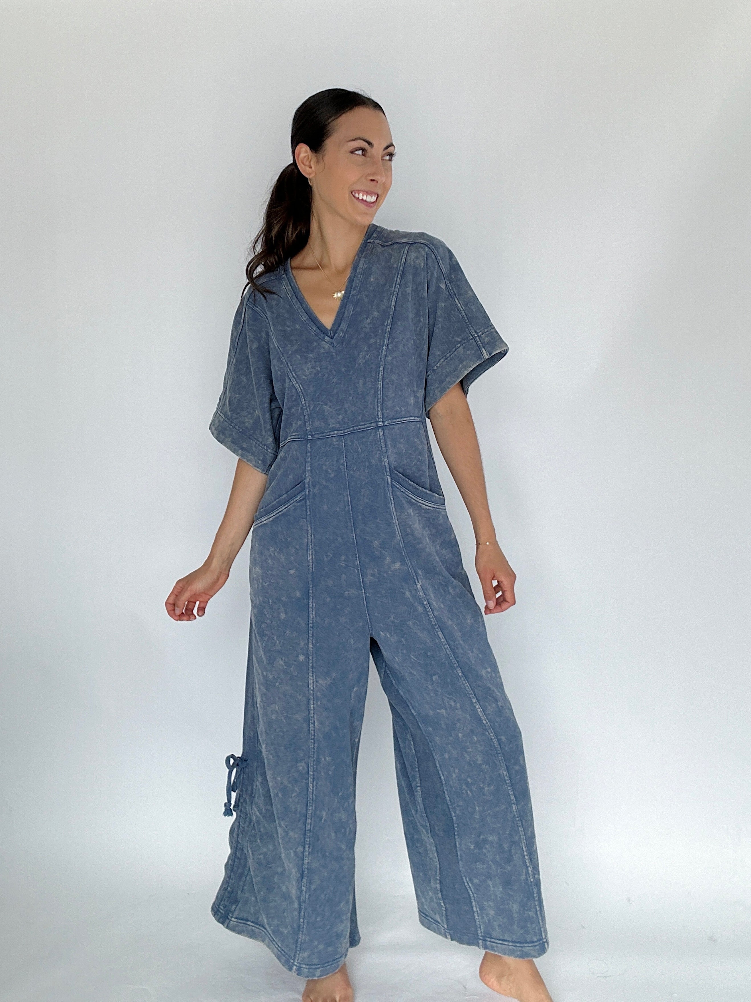 Woman wearing a blue jumpsuit on a white background