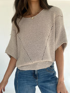 Oatmeal knit sweater with 3/4 sleeves with jeans on a white background