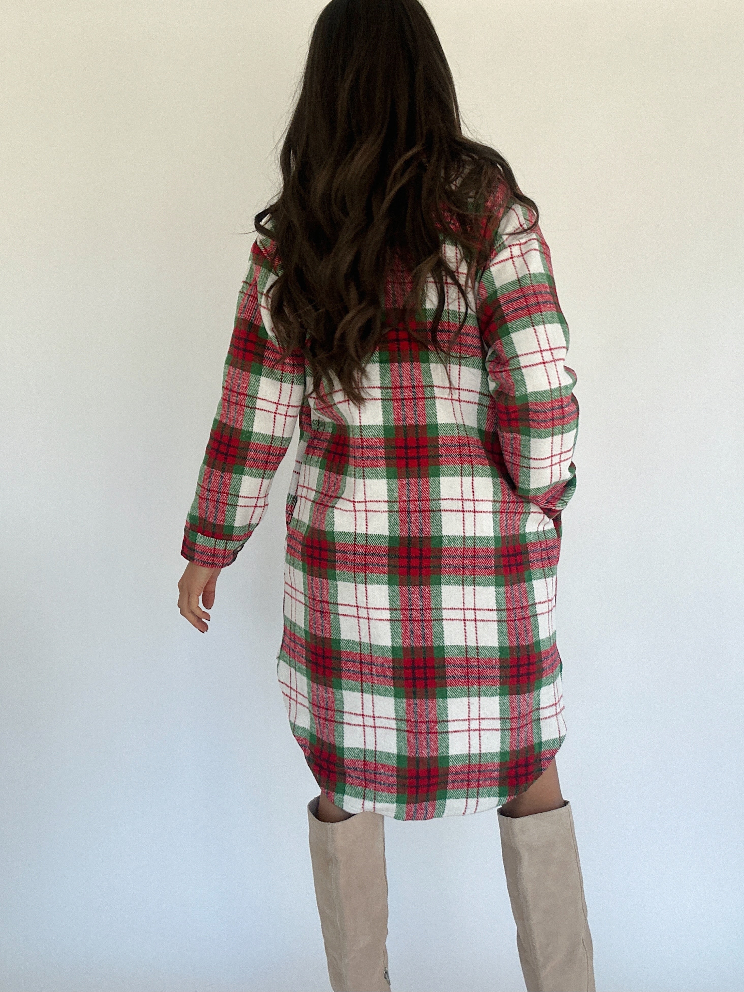 Person wearing a plaid coat with a plain background
