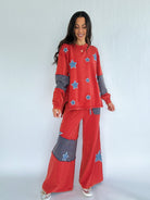 Woman wearing a red outfit with star patches on a white background