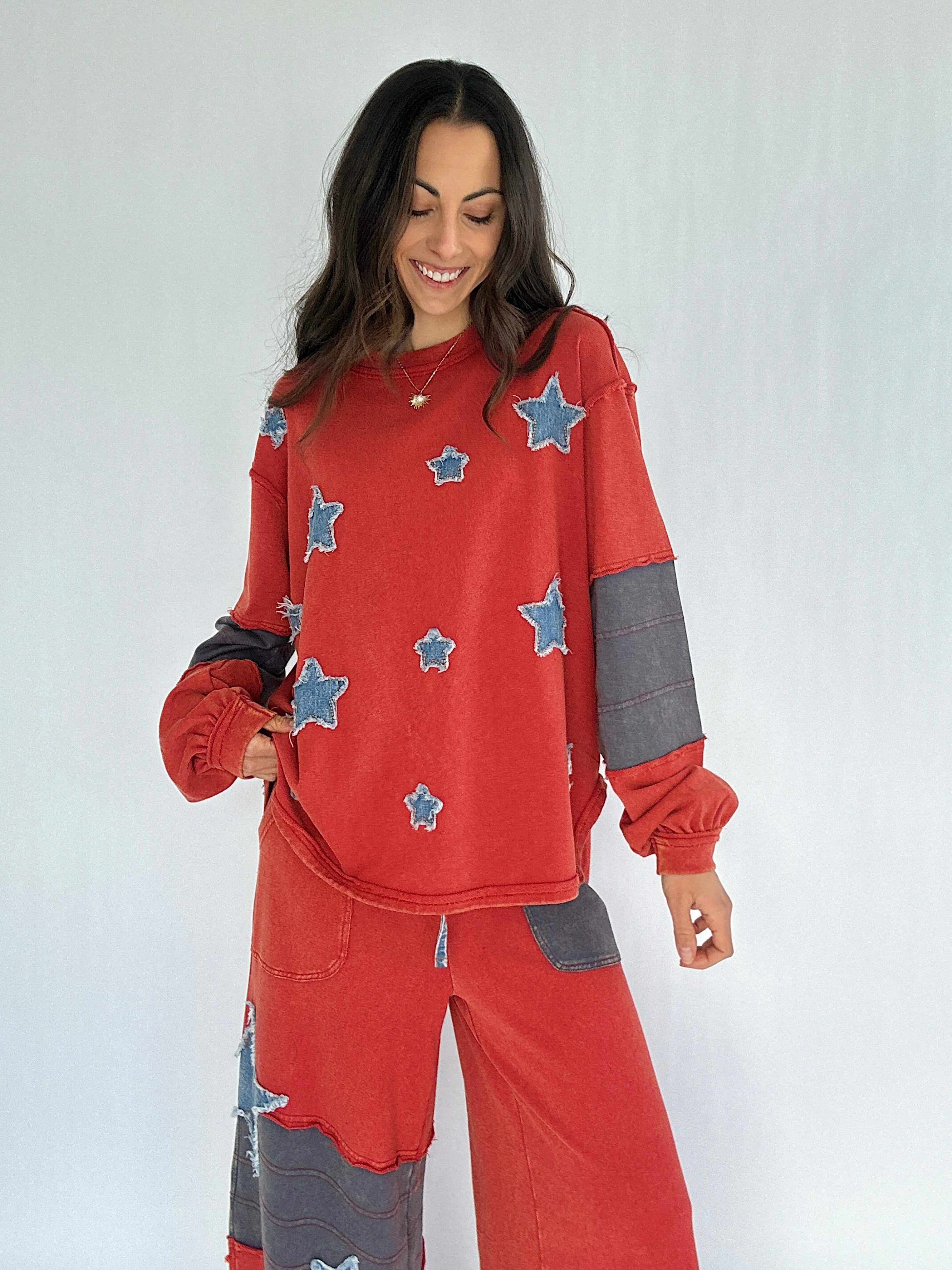Woman wearing a red outfit with star patches on a white background