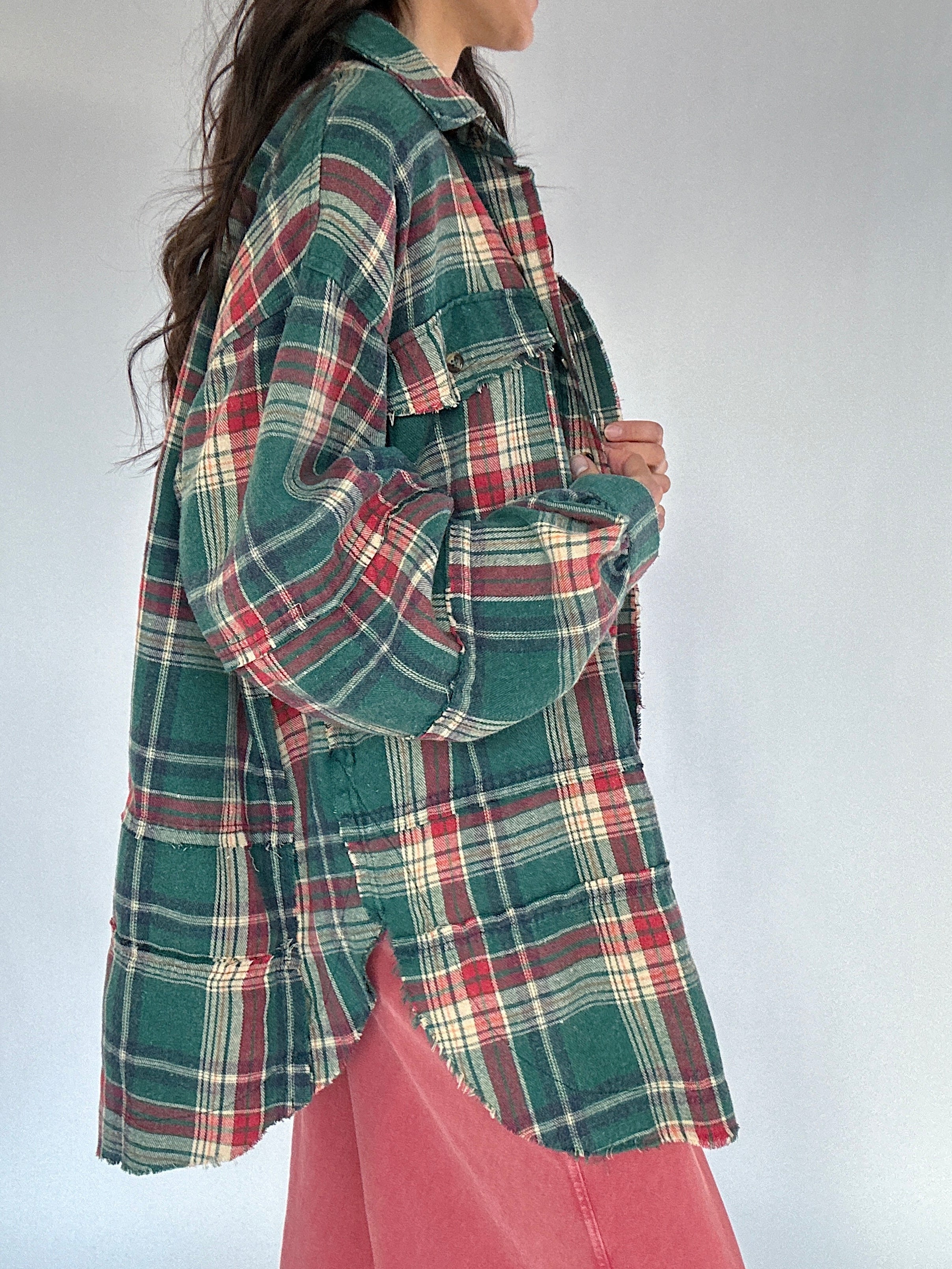 Person wearing a plaid shirt with a white background showing side details