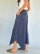 Person wearing blue waffle knit wide leg pants with a white background