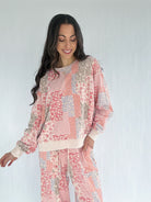 Woman wearing a floral patchwork outfit on a white background