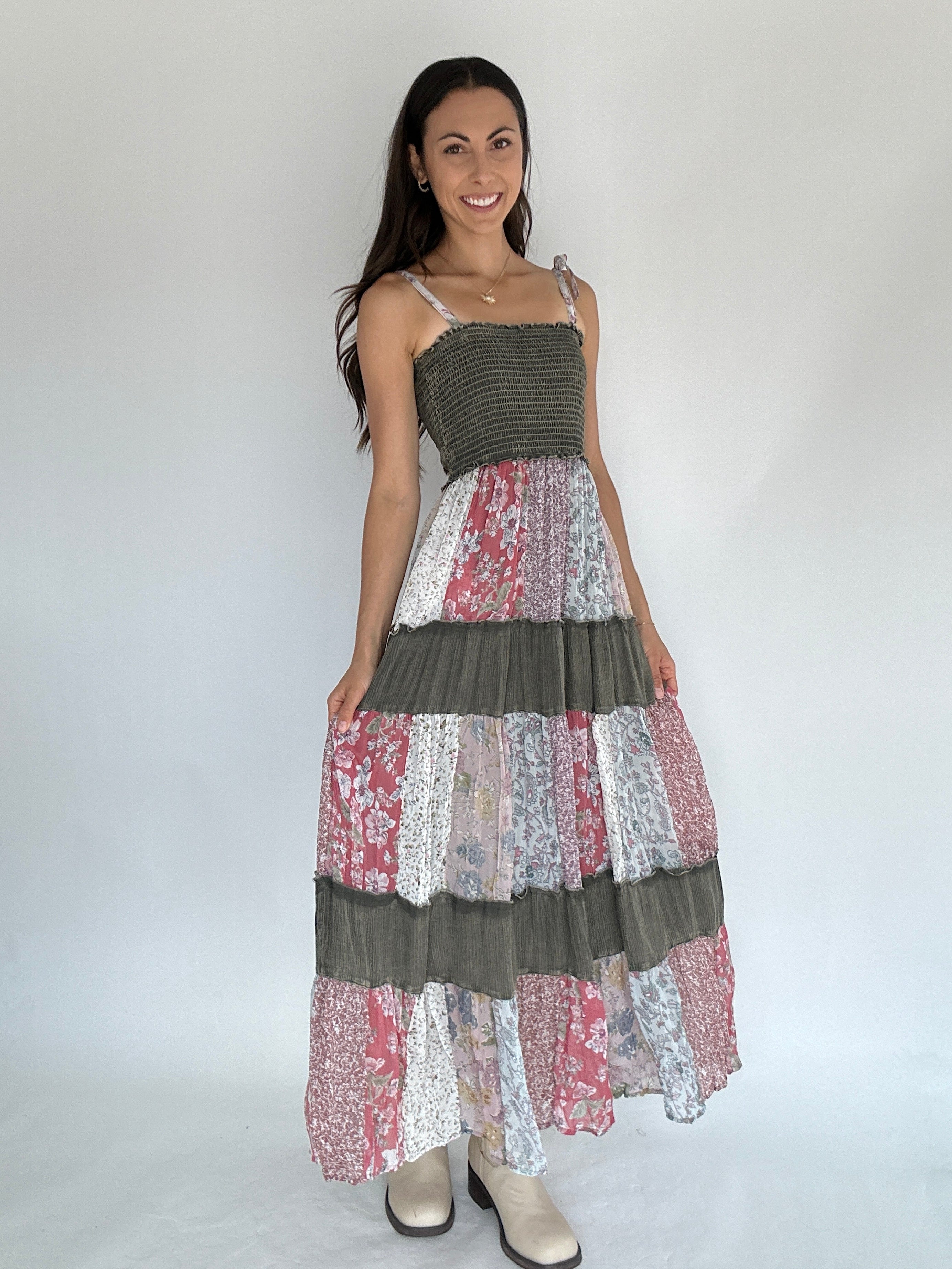 Woman wearing a patchwork dress with a plain background