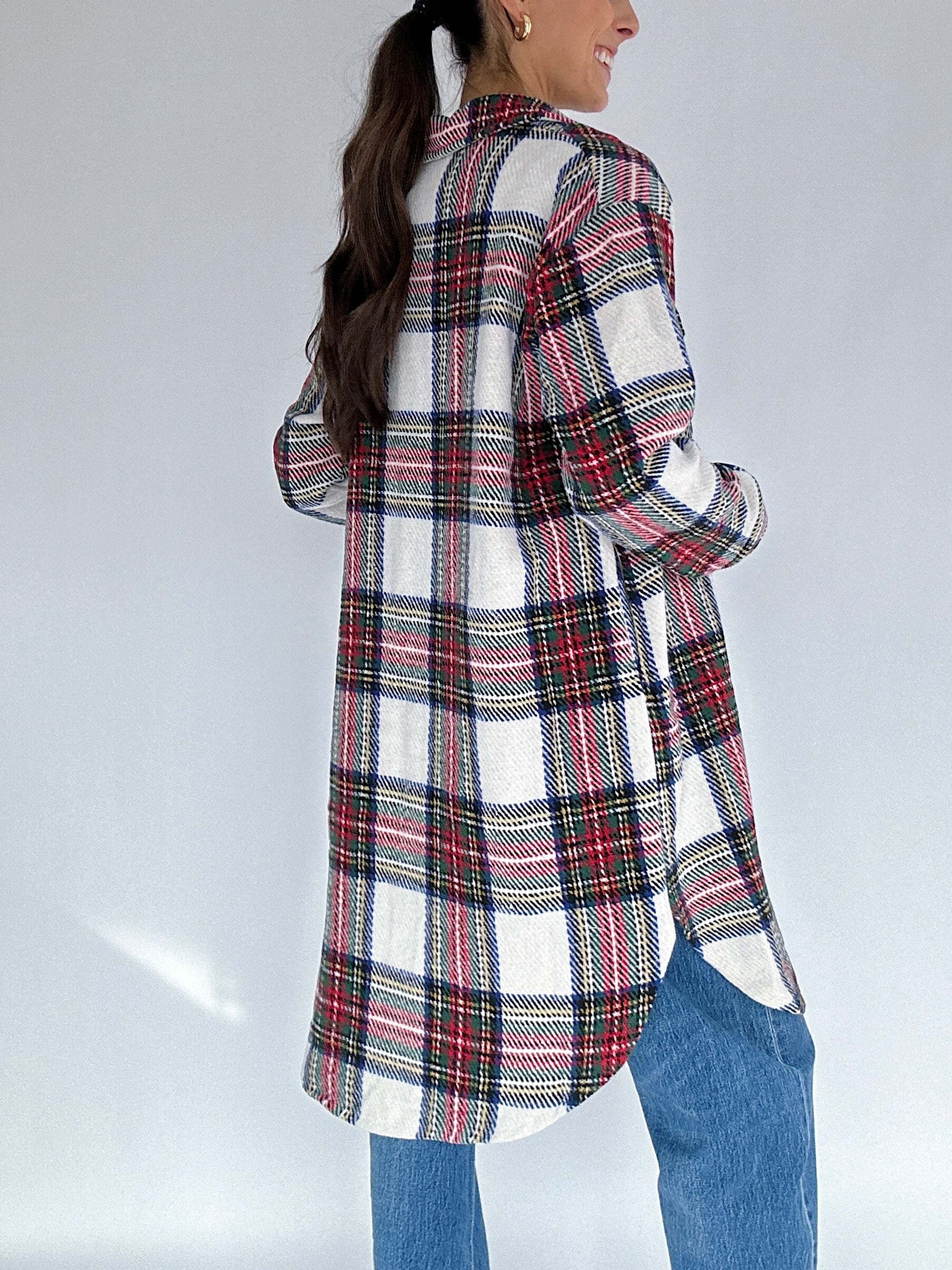 Person wearing a plaid jacket with a white background back view